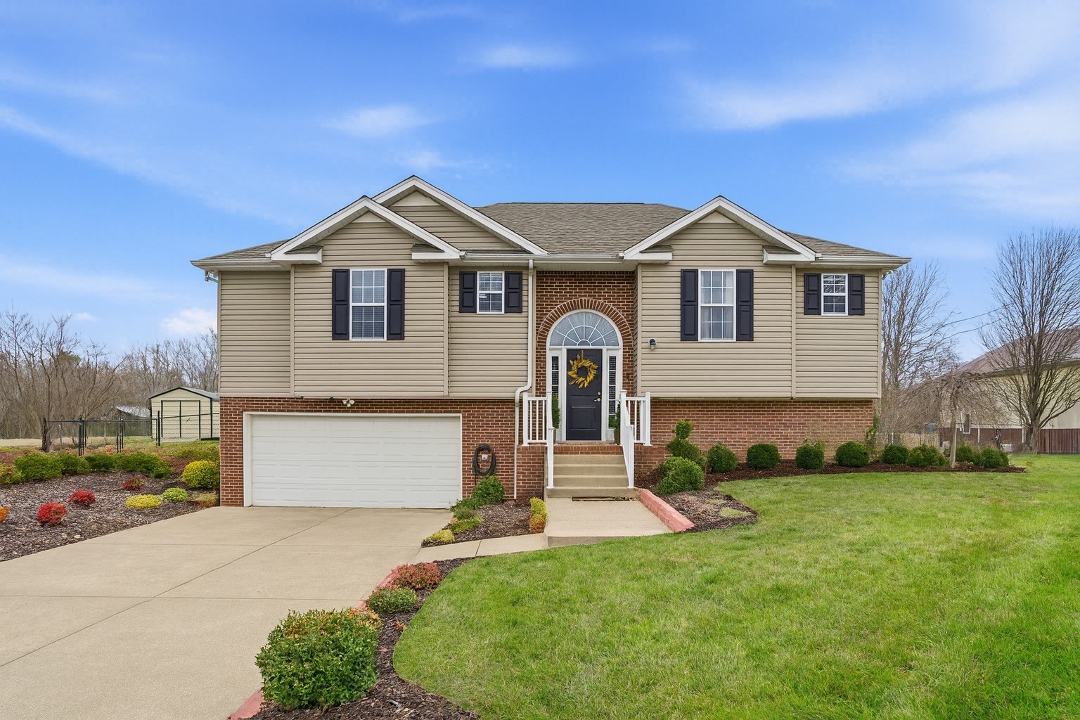 a front view of a house with a yard and garage