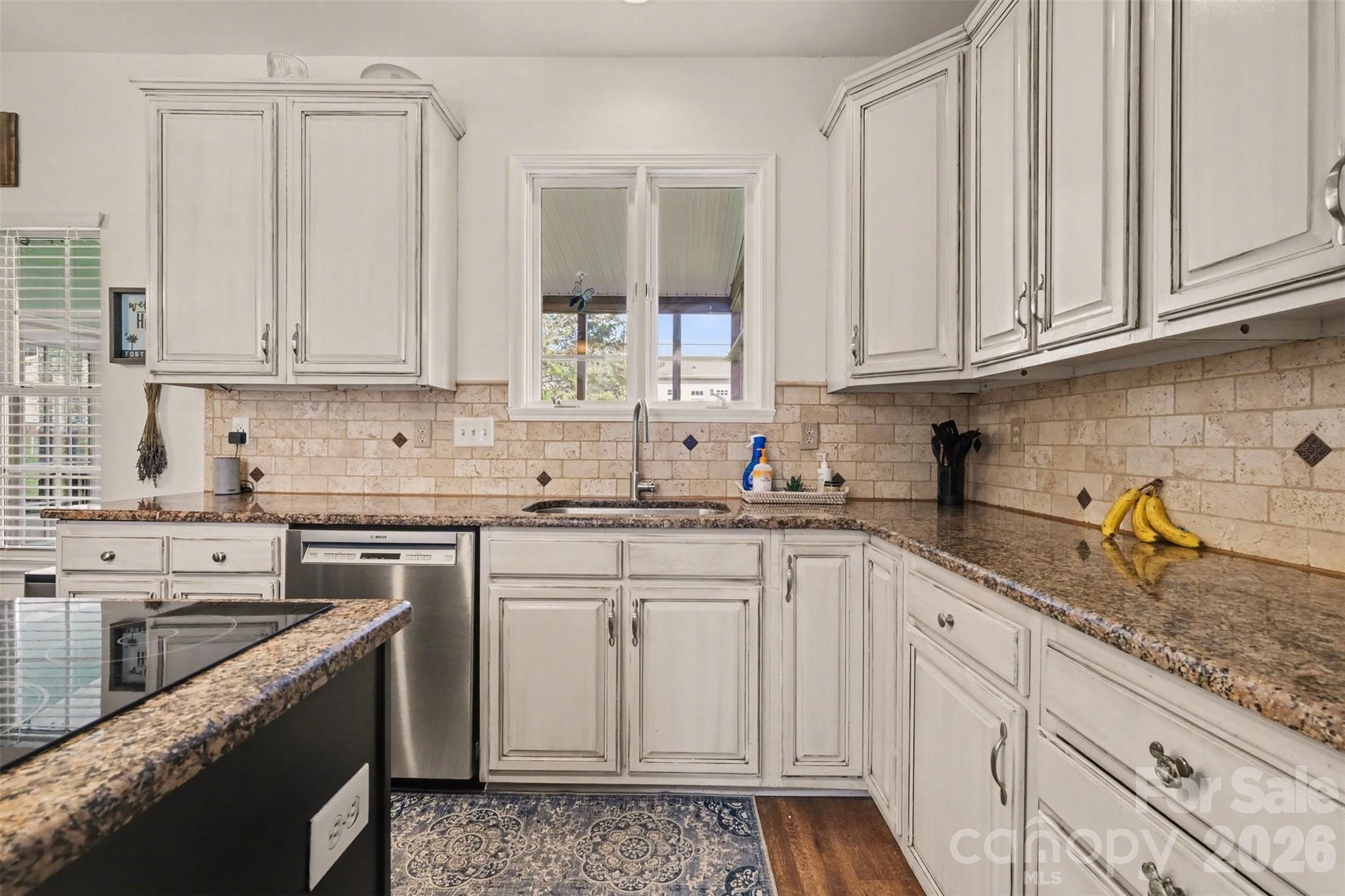 523 Whitehead Court Fort Mill, SC 29708 - Photo 15 of 48 a kitchen with granite countertop white cabinets stainless steel appliances and a sink