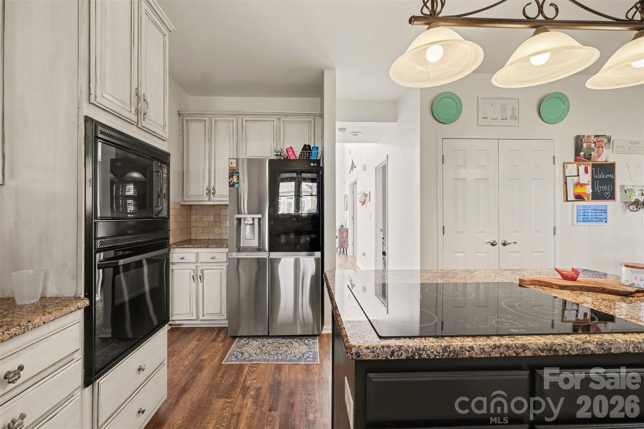 523 Whitehead Court Fort Mill, SC 29708 - Photo 16 of 48 a kitchen with granite countertop a sink a stove and refrigerator