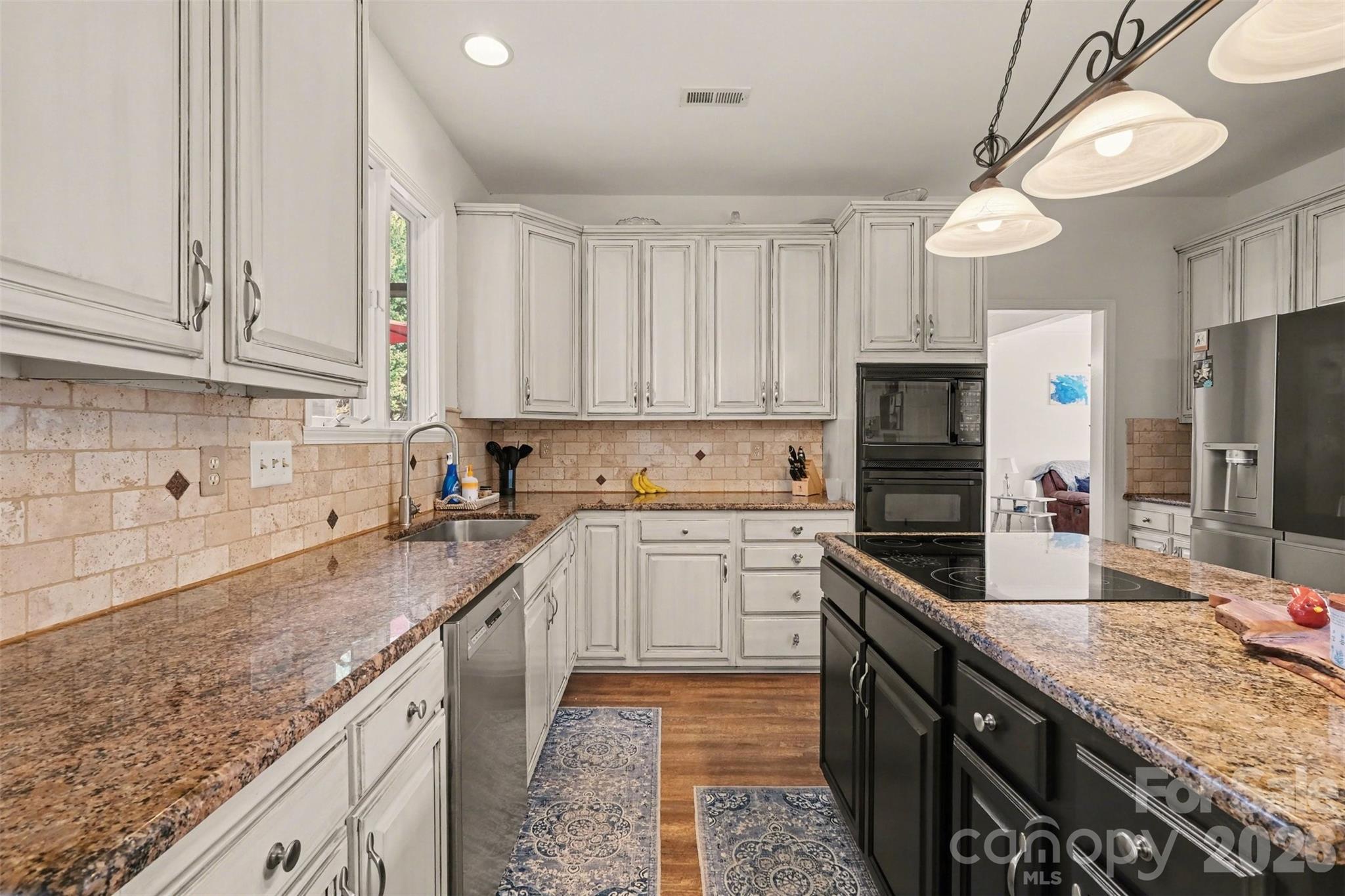 523 Whitehead Court Fort Mill, SC 29708 - Photo 17 of 48 a kitchen with granite countertop a sink a counter space appliances and cabinets
