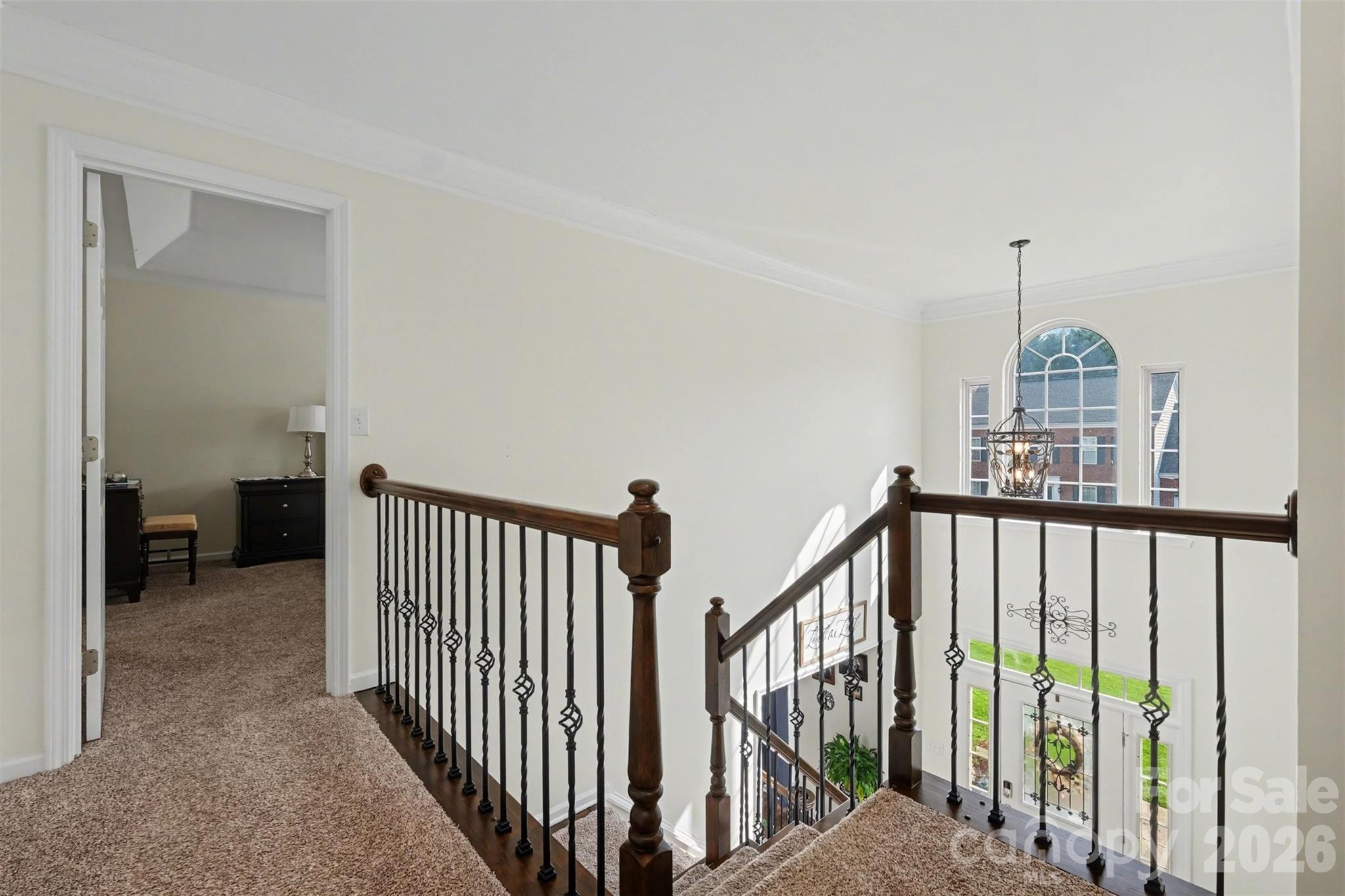 523 Whitehead Court Fort Mill, SC 29708 - Photo 22 of 48 a view of a hallway with wooden staircase and door