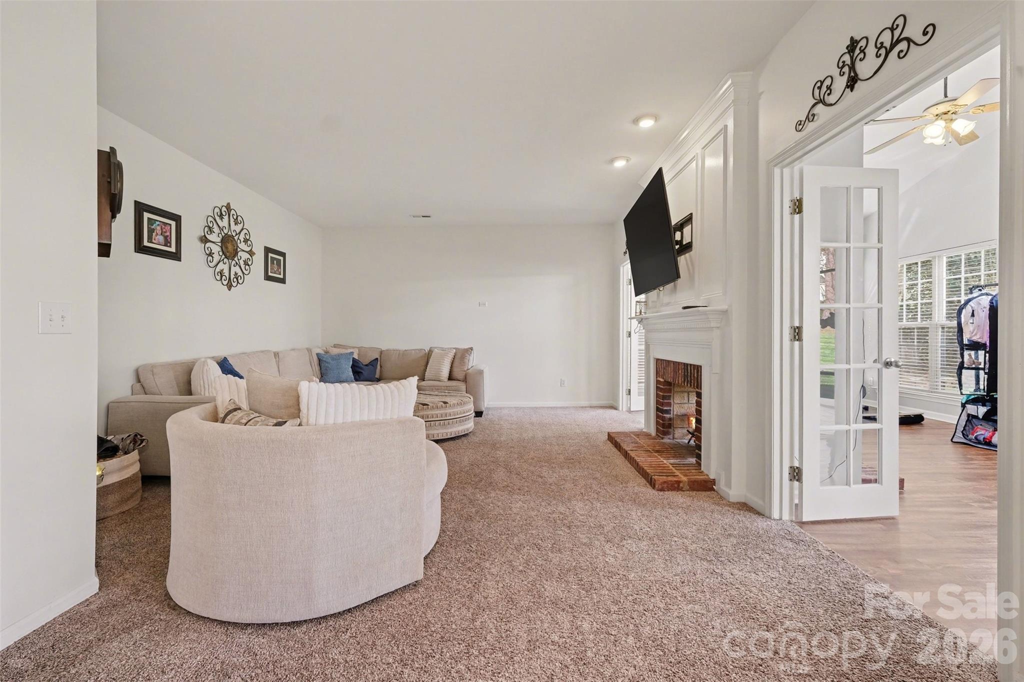 523 Whitehead Court Fort Mill, SC 29708 - Photo 10 of 48 a living room with furniture a fireplace and a flat screen tv