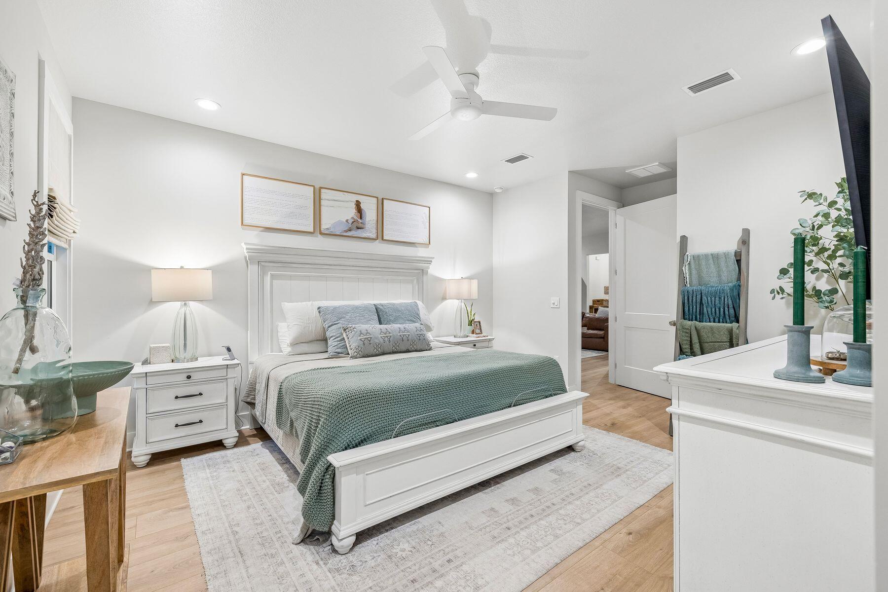 39 West Captain Fritz Way Freeport, FL 32439 - Photo 13 of 33 a spacious bedroom with a bed a mirror and lamp