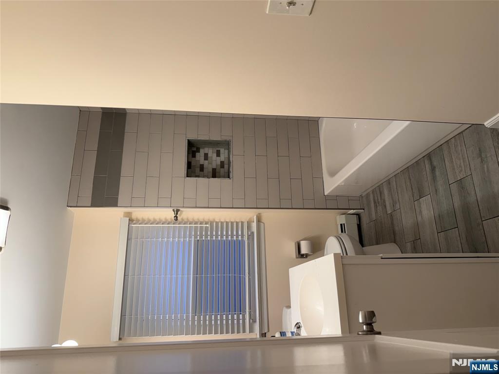 40 Hope Street, Unit 1 East Rutherford, NJ 07073 - Photo 12 of 14 a bathroom with a sink and a bathtub