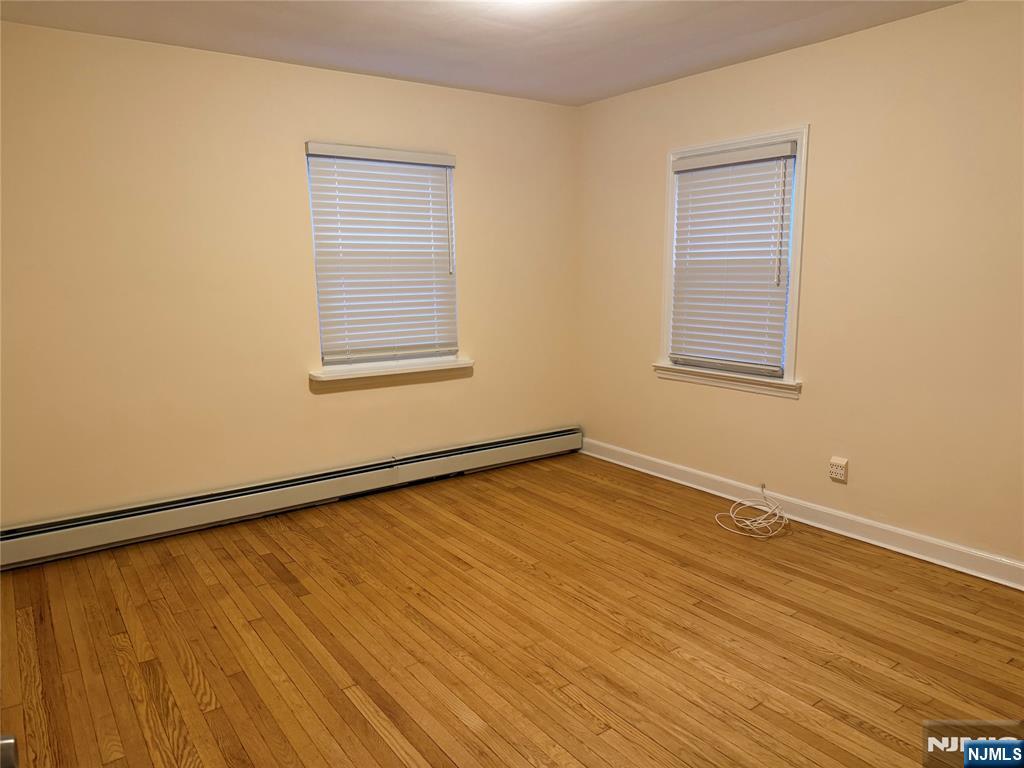 40 Hope Street, Unit 1 East Rutherford, NJ 07073 - Photo 13 of 14 a view of an empty room with wooden floor and a window