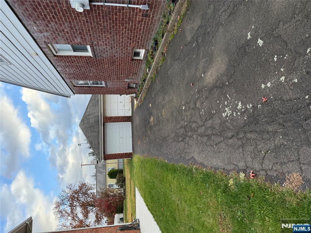 40 Hope Street, Unit 1 East Rutherford, NJ 07073 - Photo 2 of 14 a front view of a house with a yard and garage