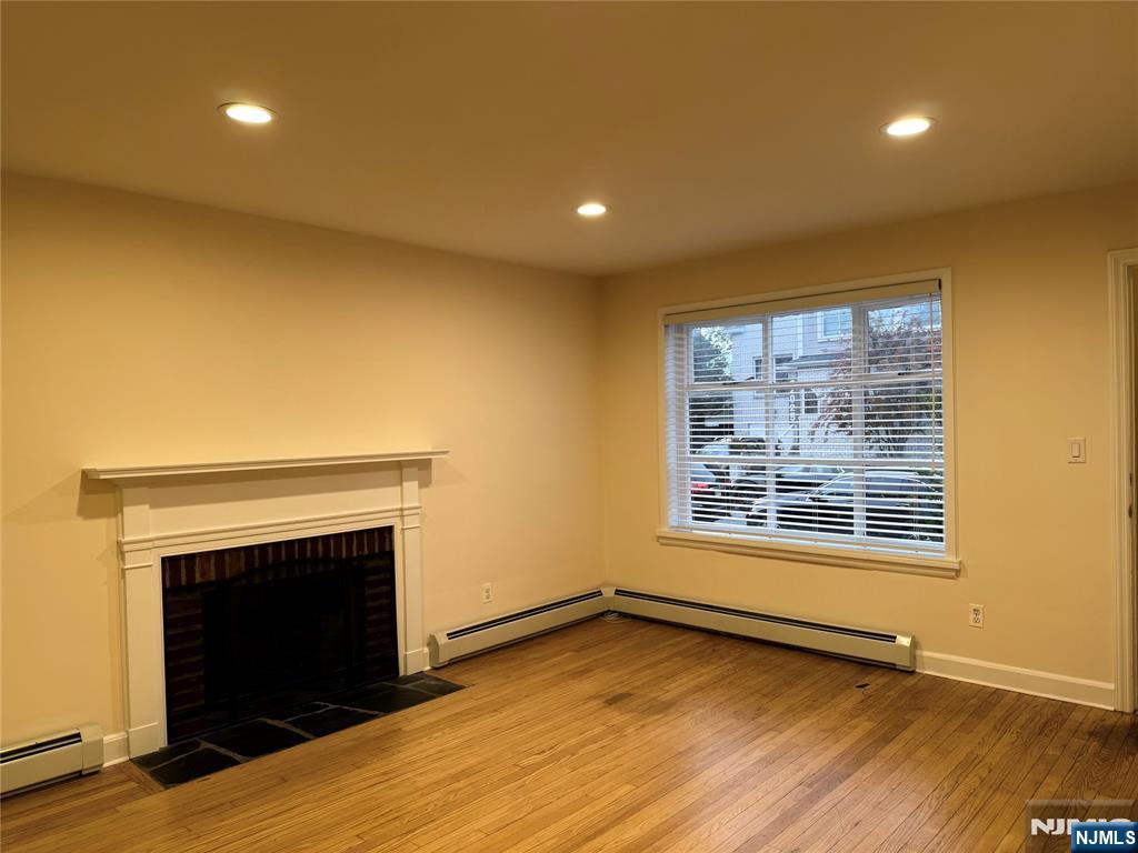 40 Hope Street, Unit 1 East Rutherford, NJ 07073 - Photo 5 of 14 a view of an empty room with wooden floor and a window
