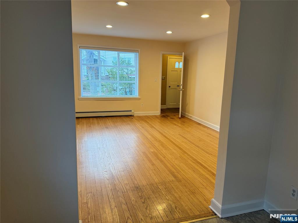 40 Hope Street, Unit 1 East Rutherford, NJ 07073 - Photo 6 of 14 an empty room with wooden floor and windows