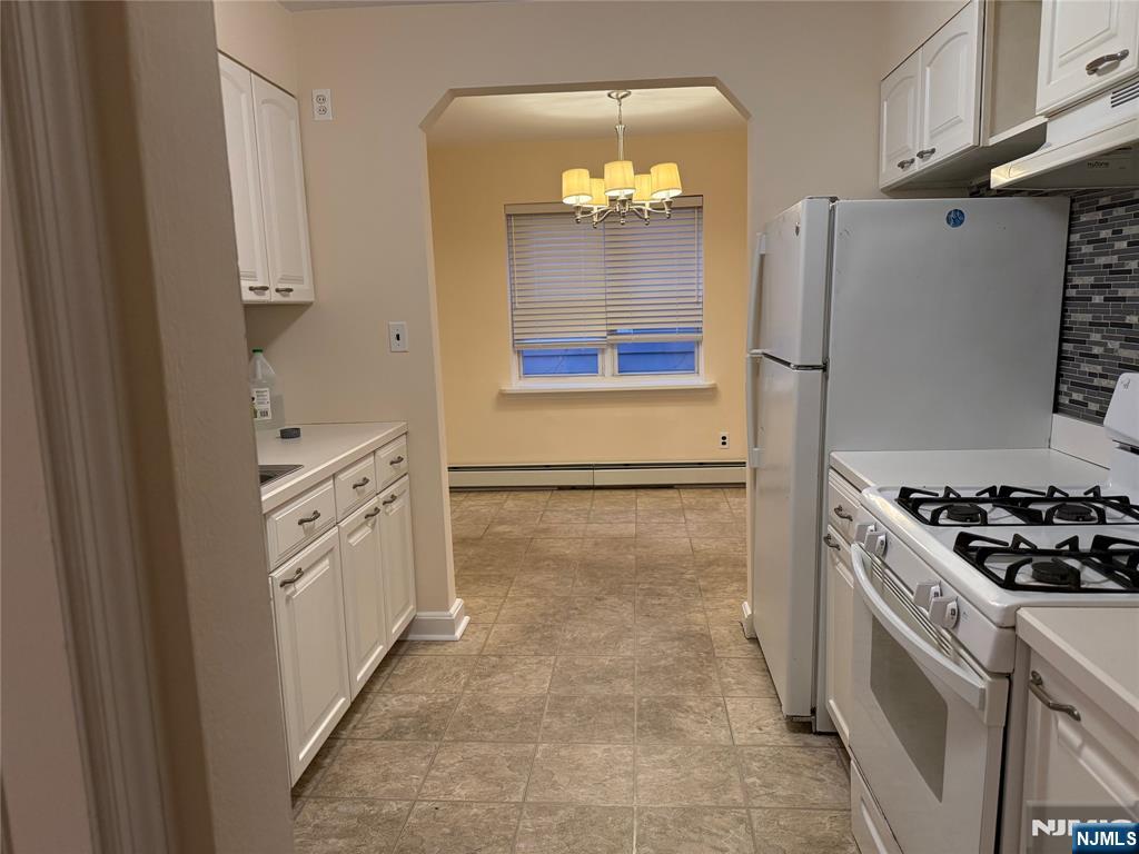 40 Hope Street, Unit 1 East Rutherford, NJ 07073 - Photo 10 of 14 a kitchen with stainless steel appliances a refrigerator and a stove