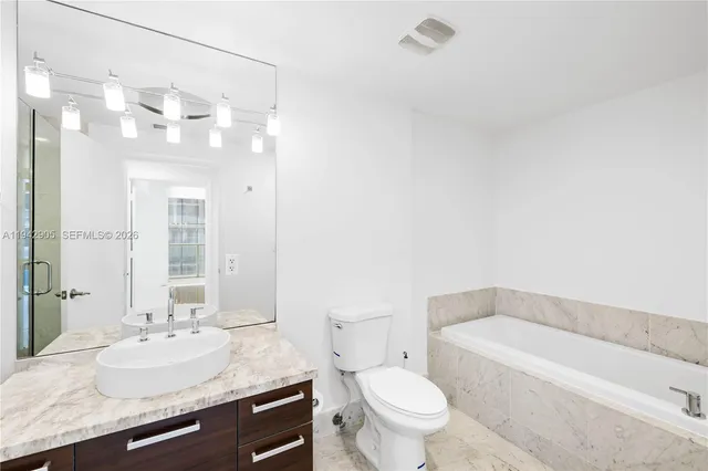 a bathroom with a sink double vanity mirror and shower