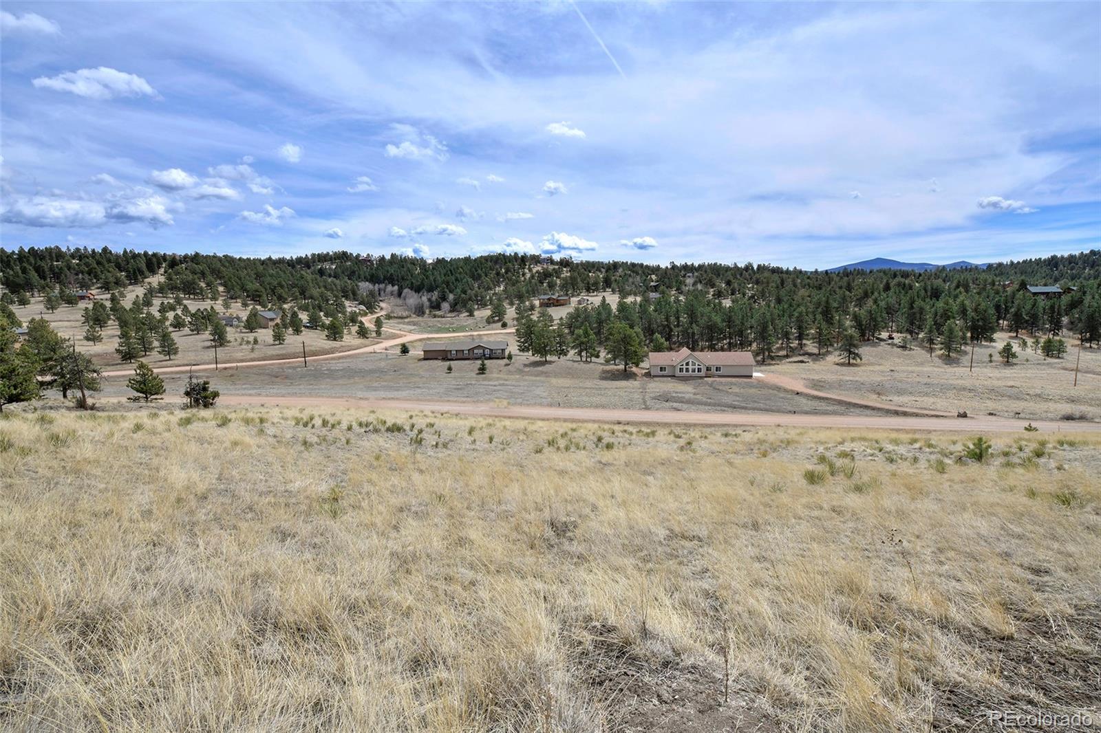 81 High Pasture Road Florissant, CO 80816 - Photo 11 of 26 a view of a lake with beach and city