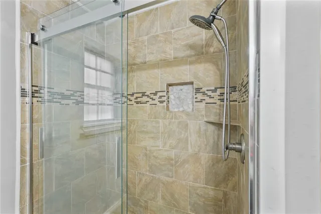 a bathroom with a glass shower door