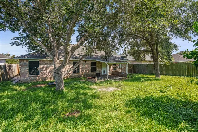 a front view of house with yard patio and green space