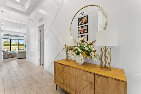 a large room with lots of white furniture and a large window