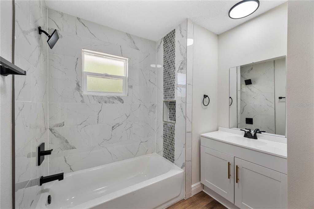 1215 El Camino Road Lakeland, FL 33805 - Photo 17 of 34 a bathroom with a bathtub and a sink