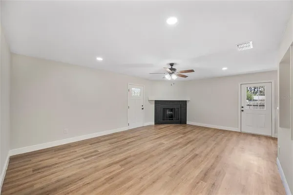 wooden floor in an empty room with a window