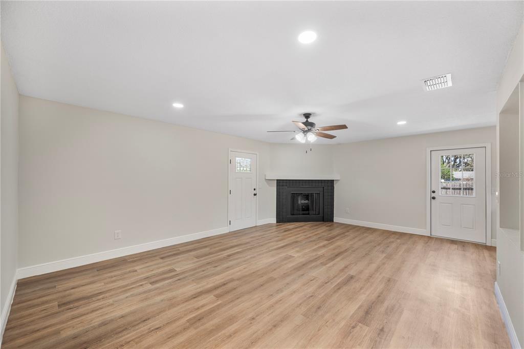 1215 El Camino Road Lakeland, FL 33805 - Photo 20 of 34 wooden floor in an empty room with a window