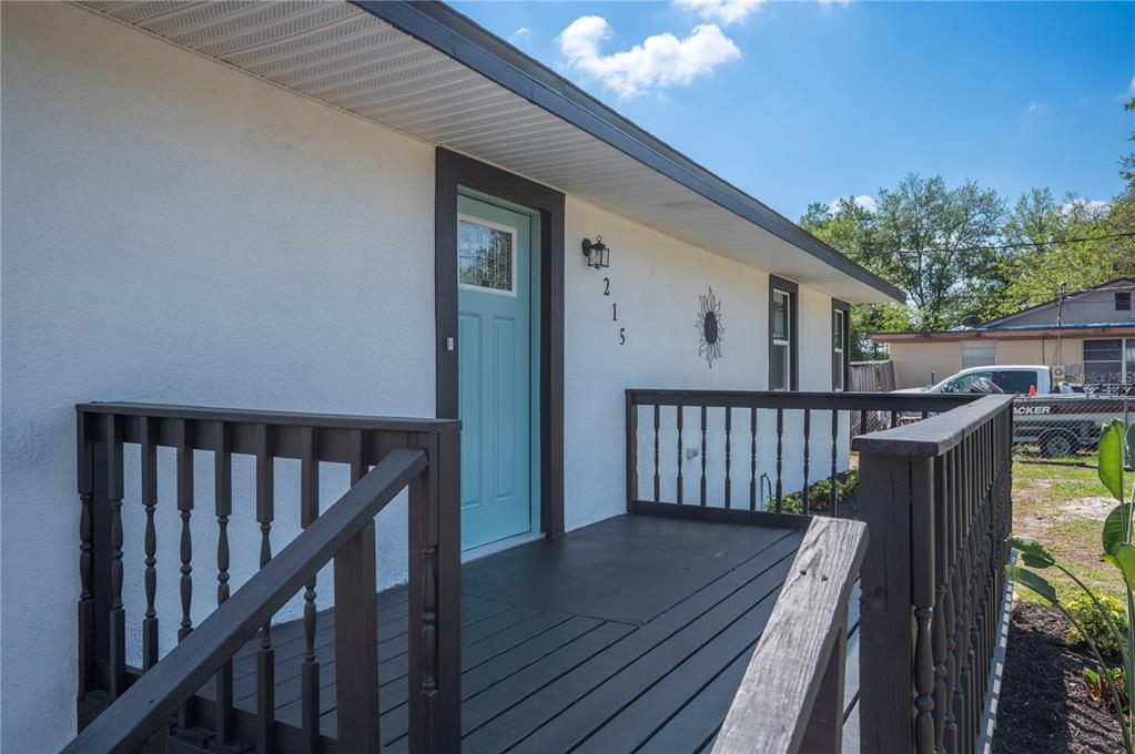 1215 El Camino Road Lakeland, FL 33805 - Photo 2 of 34 a view of balcony with wooden floor and fence and a barbeque
