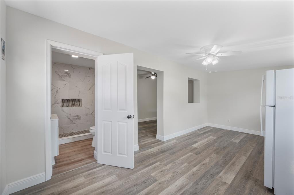 1215 El Camino Road Lakeland, FL 33805 - Photo 24 of 34 an empty room with wooden floor and a ceiling fan