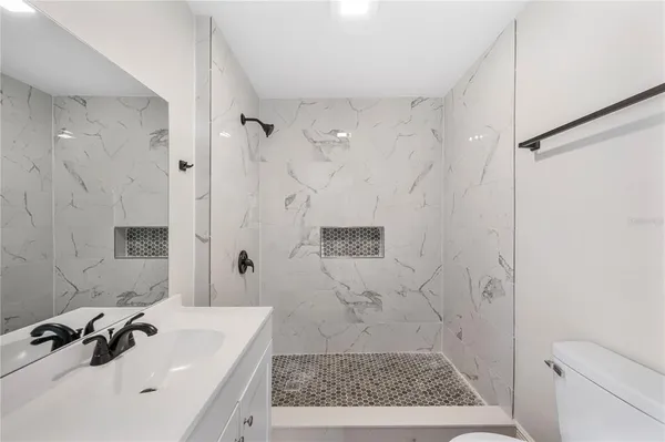 a bathroom with a bathtub sink and toilet