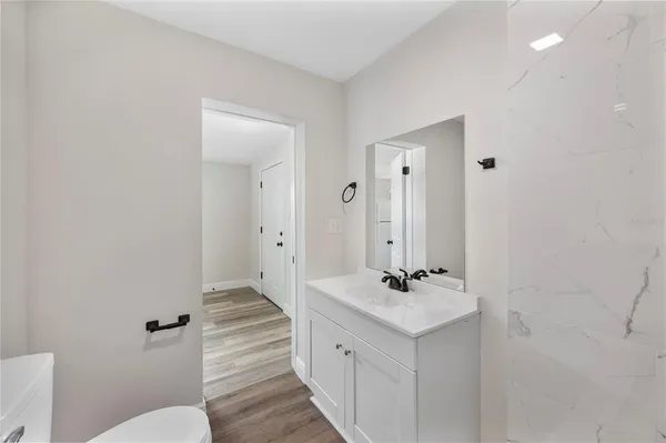 a bathroom with a double vanity sink mirror and toilet