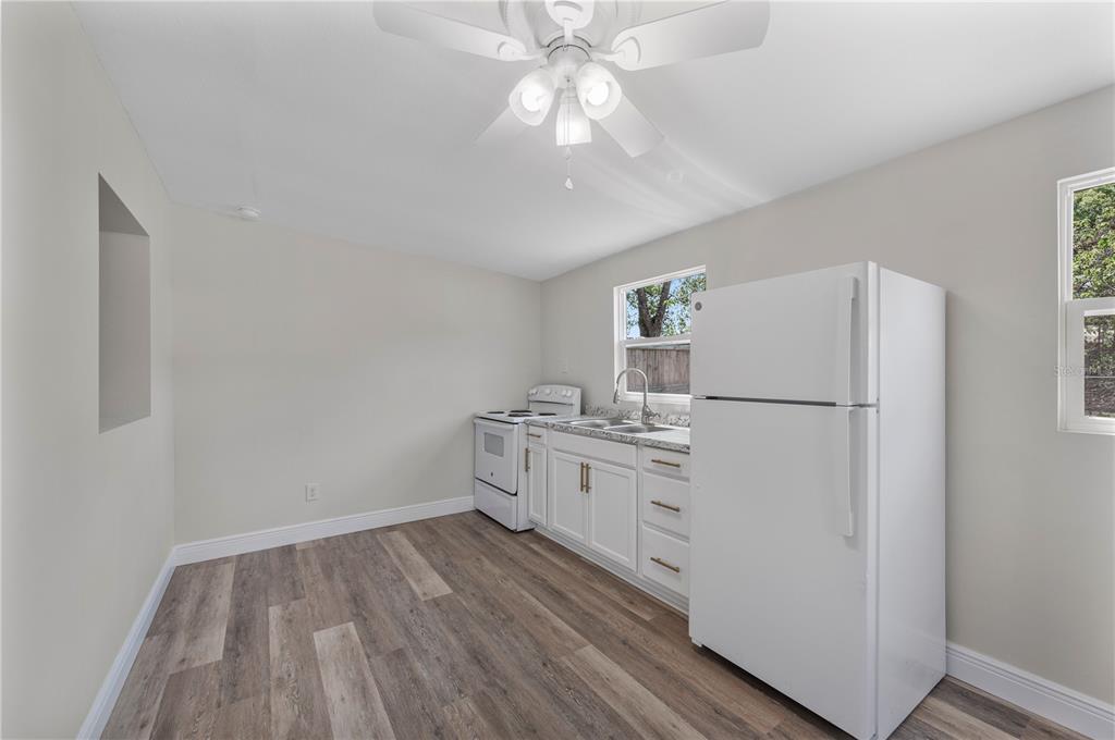 1215 El Camino Road Lakeland, FL 33805 - Photo 27 of 34 a kitchen with cabinets wooden floor and stainless steel appliances