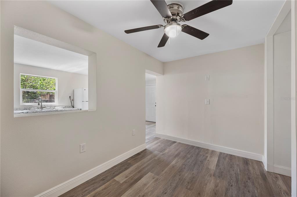 1215 El Camino Road Lakeland, FL 33805 - Photo 29 of 34 an empty room with a window and a ceiling fan