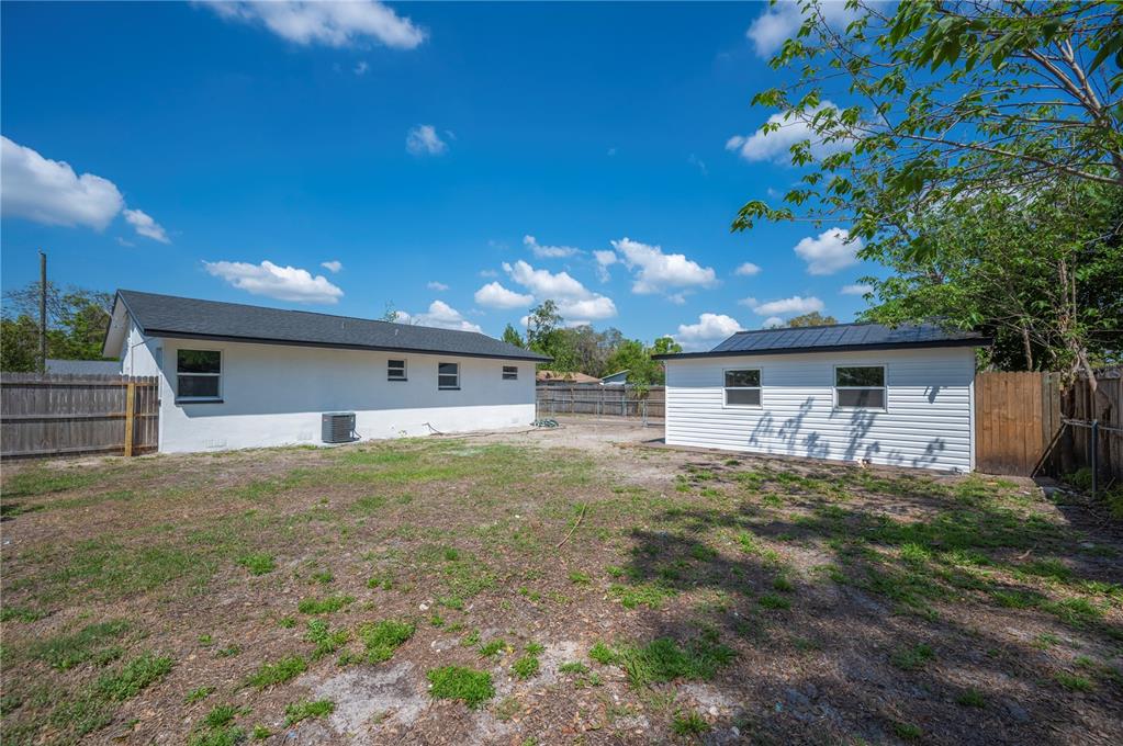 1215 El Camino Road Lakeland, FL 33805 - Photo 31 of 34 a view of a house with a yard and garage
