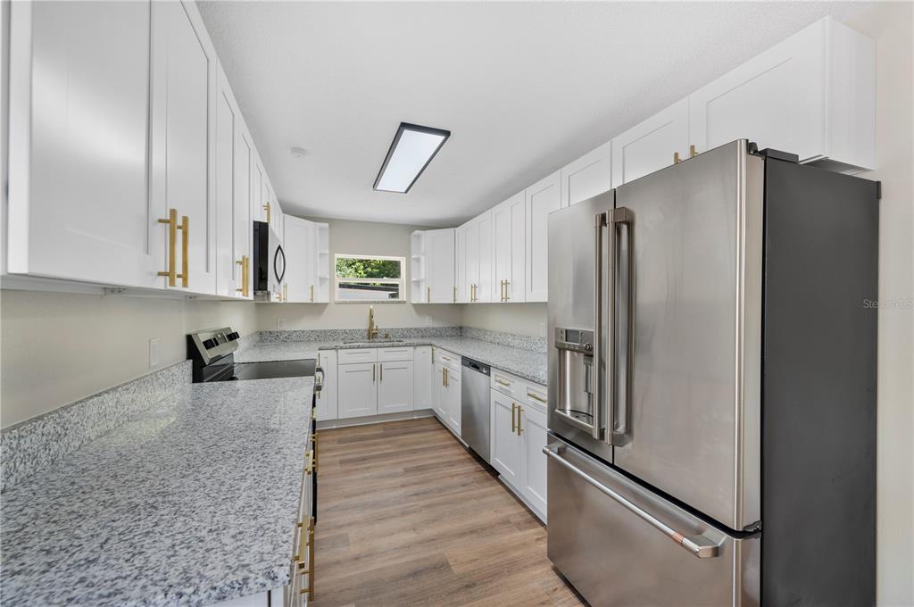 1215 El Camino Road Lakeland, FL 33805 - Photo 6 of 34 a kitchen with stainless steel appliances a refrigerator sink and cabinets