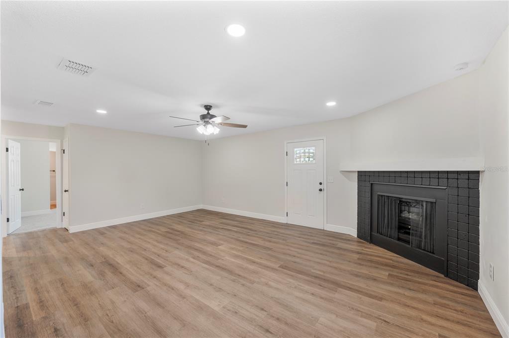 1215 El Camino Road Lakeland, FL 33805 - Photo 8 of 34 an empty room with fan and a fireplace