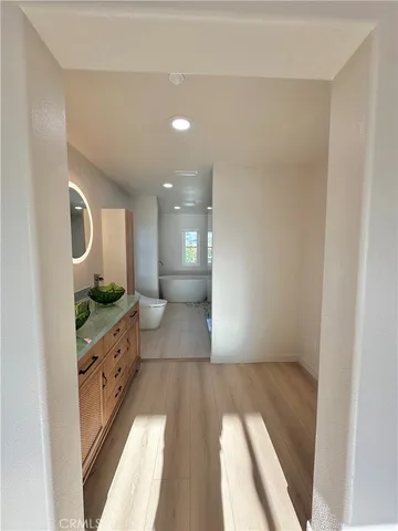 a spacious bathroom with a granite countertop double vanity and a mirror