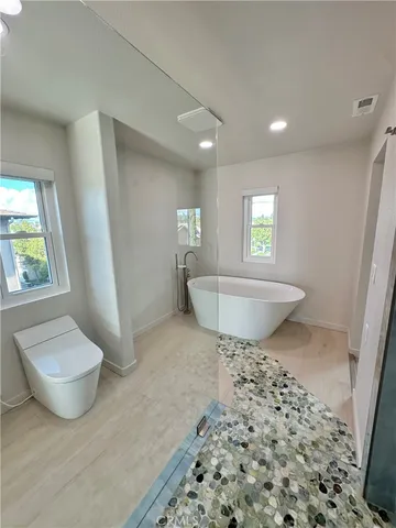 a bathroom with a bathtub and a shower