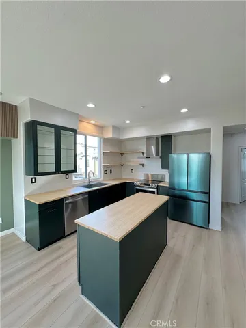 a large kitchen with stainless steel appliances kitchen island granite countertop a large counter top and oven