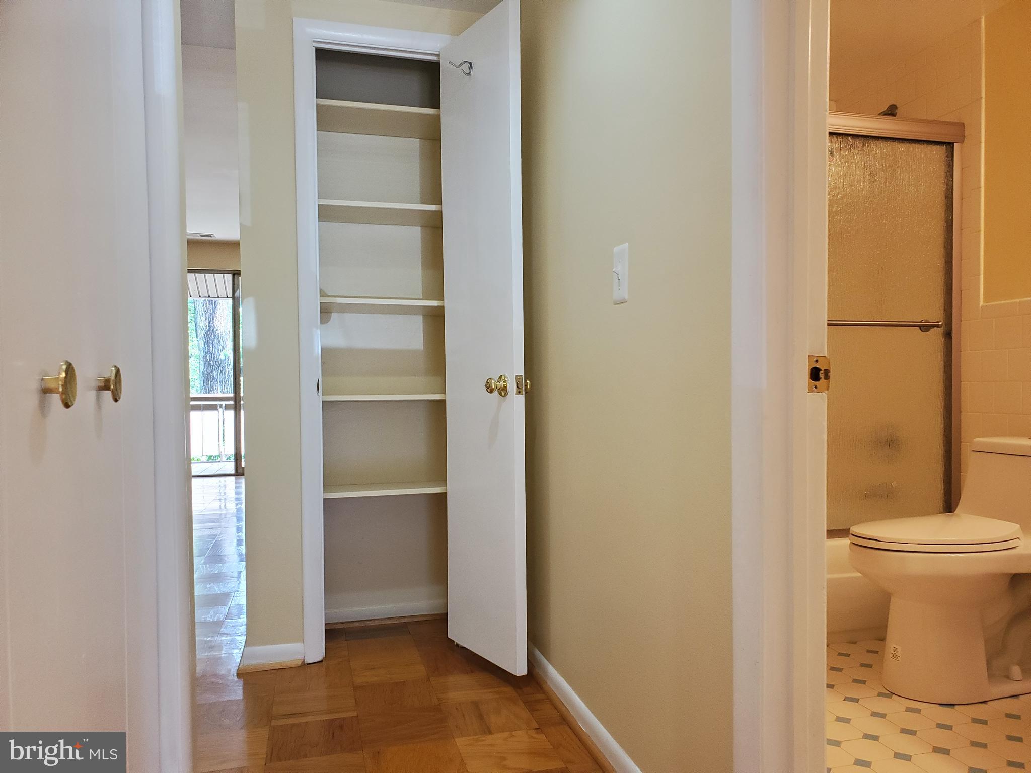 117 Cross Keys Road, Unit R117F Baltimore, MD 21210 - Photo 24 of 34 Center Hallway with Linen & Coat Closets
