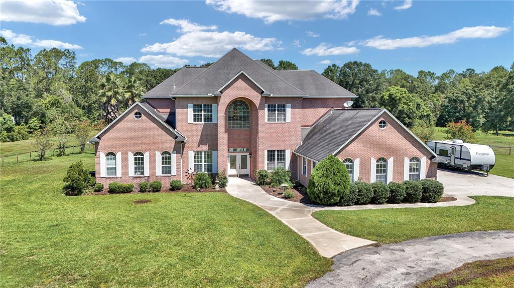 1309 Bessent Road Starke, FL 32091 - Photo 1 of 1 a front view of a house with a yard and garage