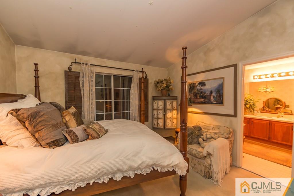 57 Fieldstone Road Bedminster, NJ 07921 - Photo 12 of 22 a bedroom with a bed and a flat tv screen on the dresser