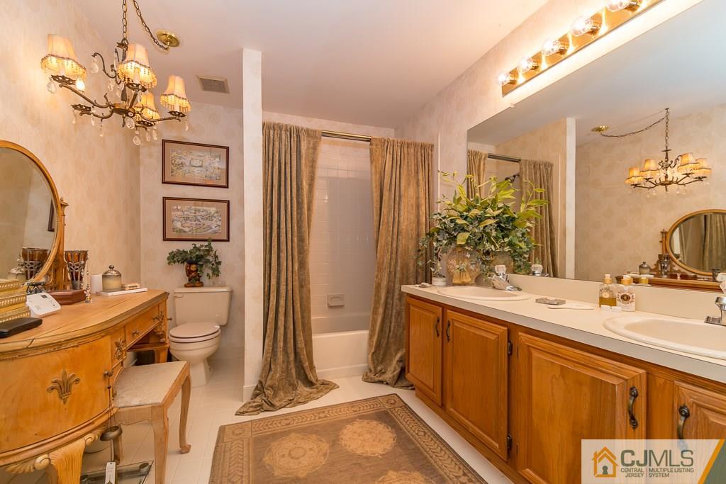 57 Fieldstone Road Bedminster, NJ 07921 - Photo 13 of 22 a bathroom with a double vanity sink mirror and shower