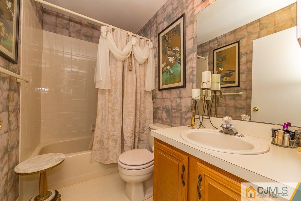 57 Fieldstone Road Bedminster, NJ 07921 - Photo 17 of 22 a bathroom with a sink toilet a mirror and shower
