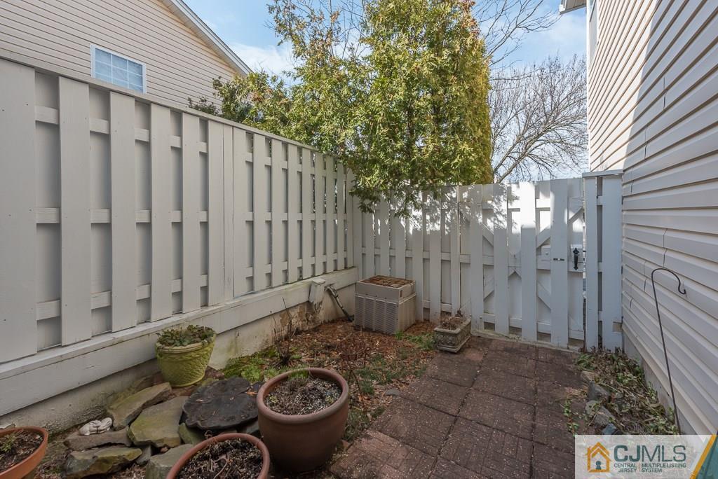 57 Fieldstone Road Bedminster, NJ 07921 - Photo 20 of 22 a view of a backyard with table and chairs with wooden fence