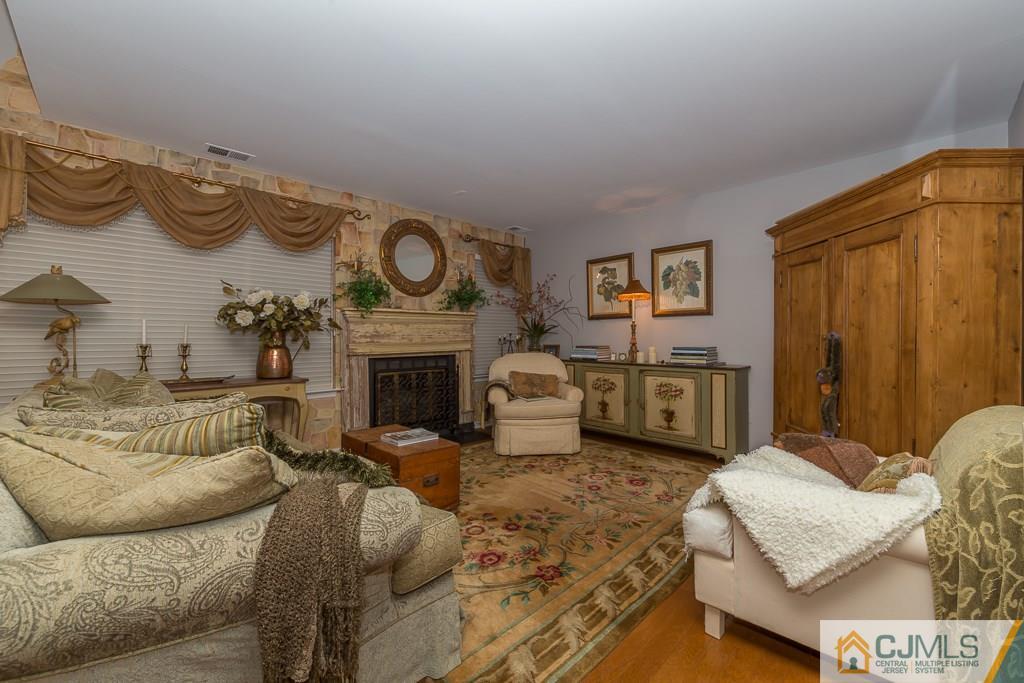 57 Fieldstone Road Bedminster, NJ 07921 - Photo 4 of 22 a living room with furniture and a fireplace