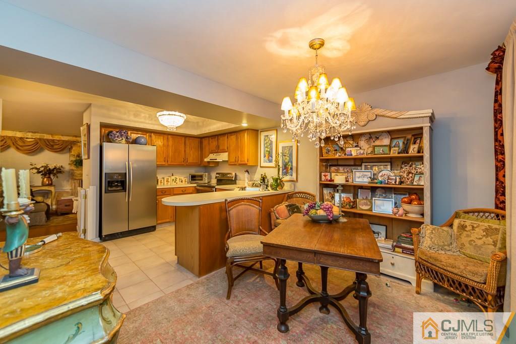 57 Fieldstone Road Bedminster, NJ 07921 - Photo 6 of 22 a view of a dining room with furniture and chandelier