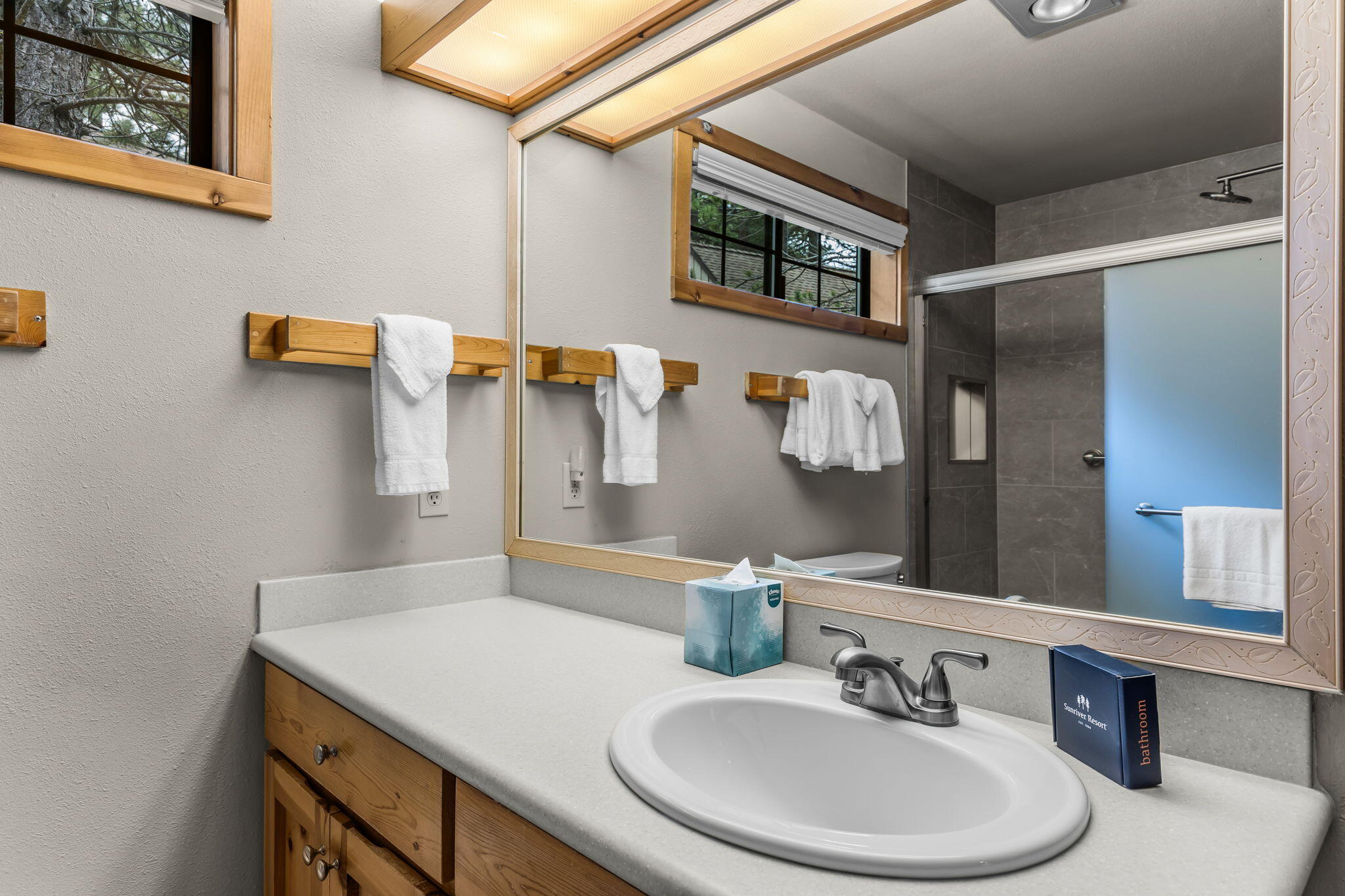57505 Circle 4 Cabin Road, Unit 29 Sunriver, OR 97707 - Photo 27 of 35 a bathroom with a sink and a mirror