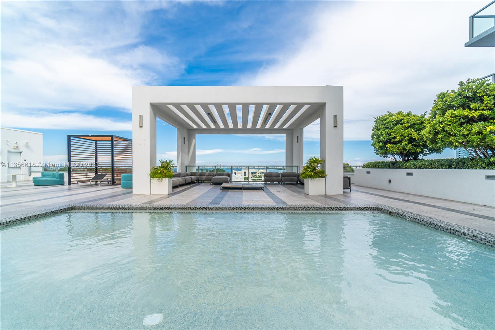 3900 Biscayne Boulevard, Unit S320 Miami, FL 33137 - Photo 1 of 42 a view of a swimming pool and lounge chair
