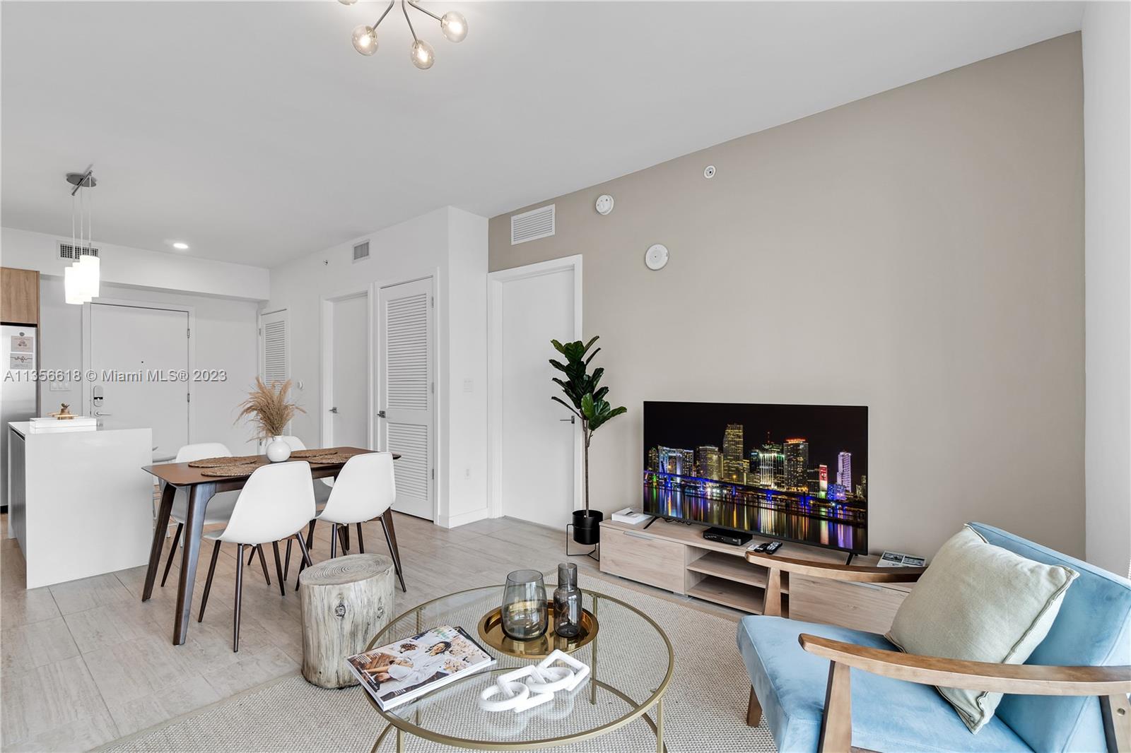 3900 Biscayne Boulevard, Unit S320 Miami, FL 33137 - Photo 11 of 42 a living room with furniture and a wooden floor