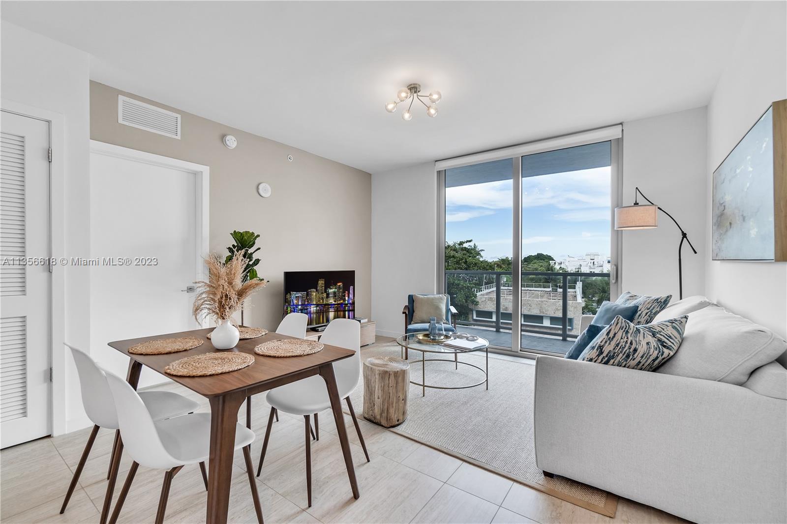 3900 Biscayne Boulevard, Unit S320 Miami, FL 33137 - Photo 12 of 42 a living room with furniture and a large window