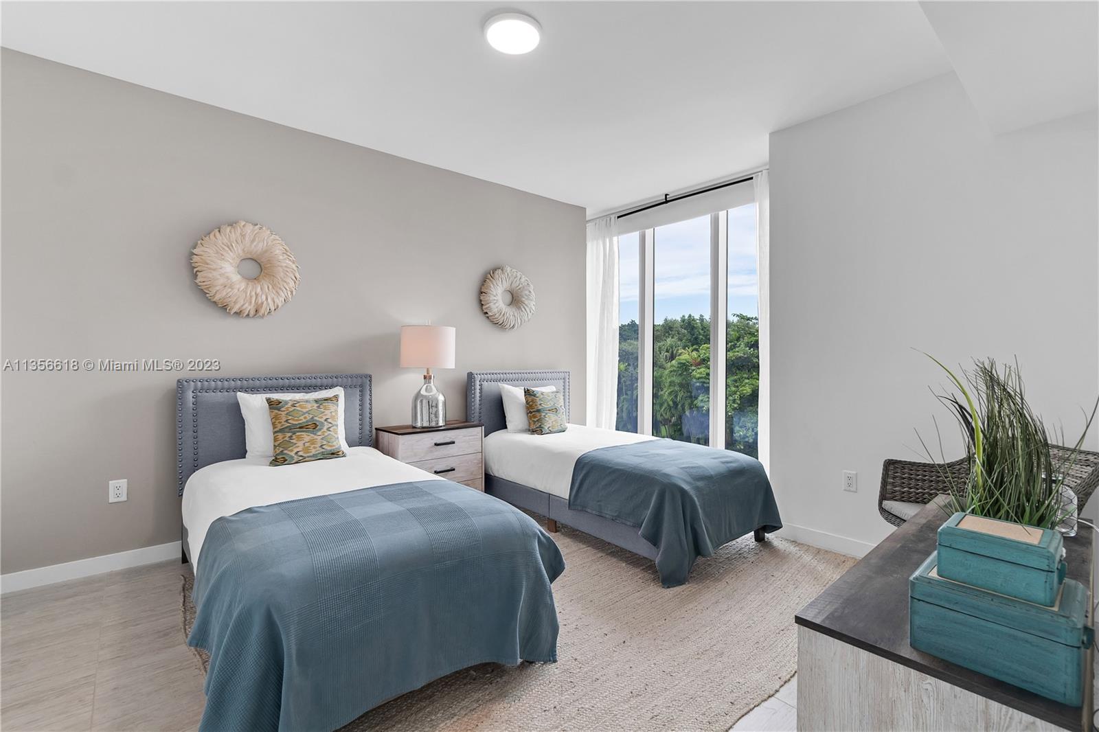 3900 Biscayne Boulevard, Unit S320 Miami, FL 33137 - Photo 13 of 42 a bedroom with two beds and potted plant with two window