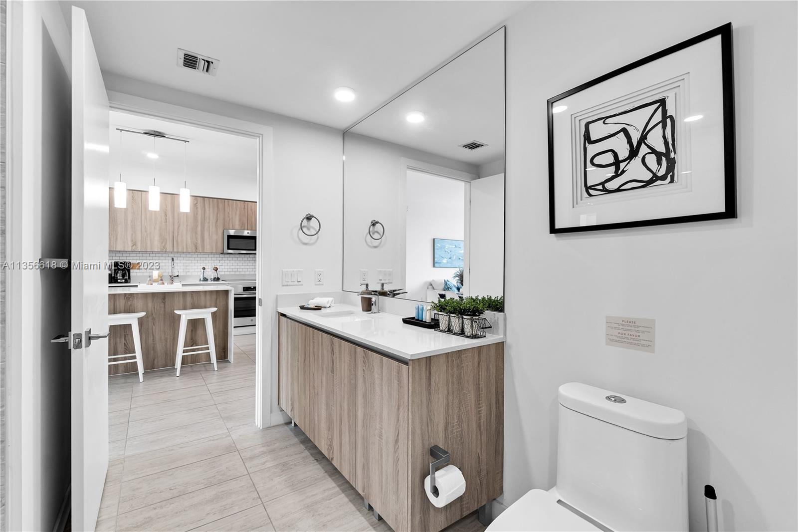 3900 Biscayne Boulevard, Unit S320 Miami, FL 33137 - Photo 19 of 42 a kitchen with a sink and chairs