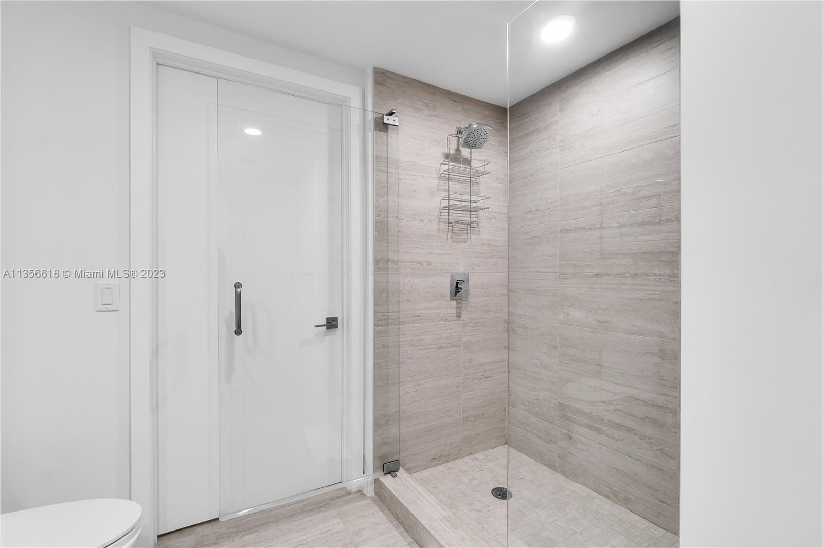 3900 Biscayne Boulevard, Unit S320 Miami, FL 33137 - Photo 20 of 42 a bathroom with a shower a toilet and sink