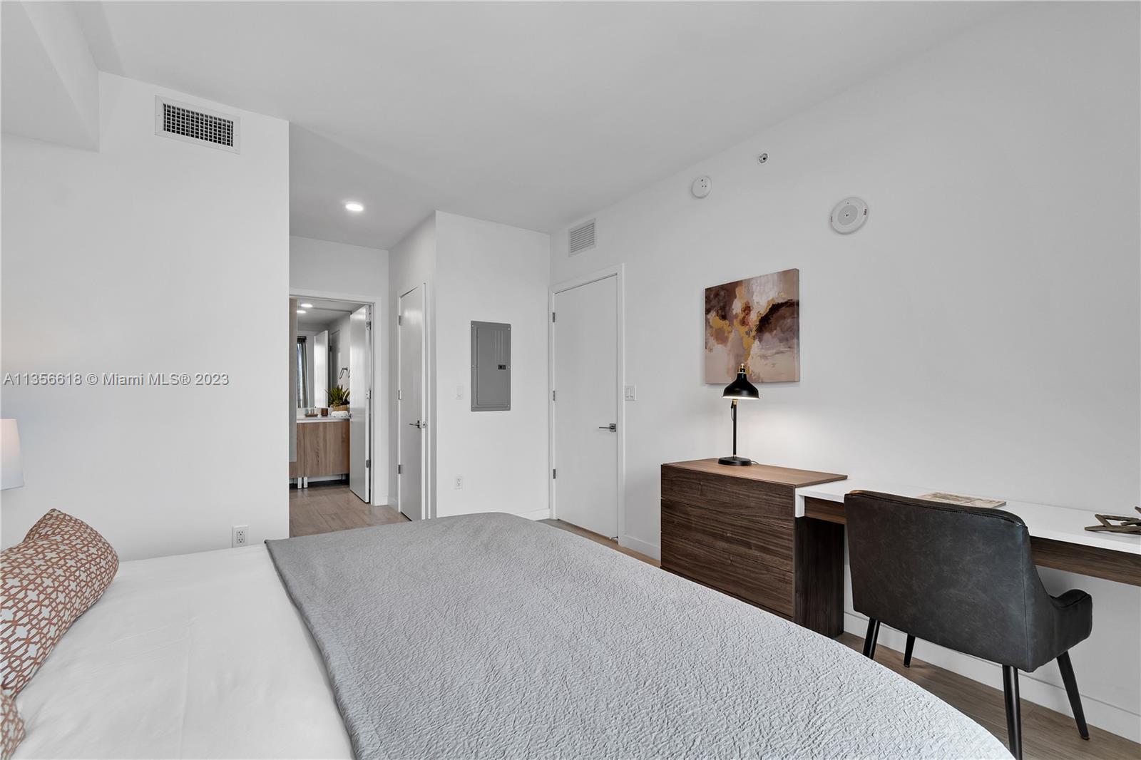 3900 Biscayne Boulevard, Unit S320 Miami, FL 33137 - Photo 22 of 42 a bedroom with a bed and a chair