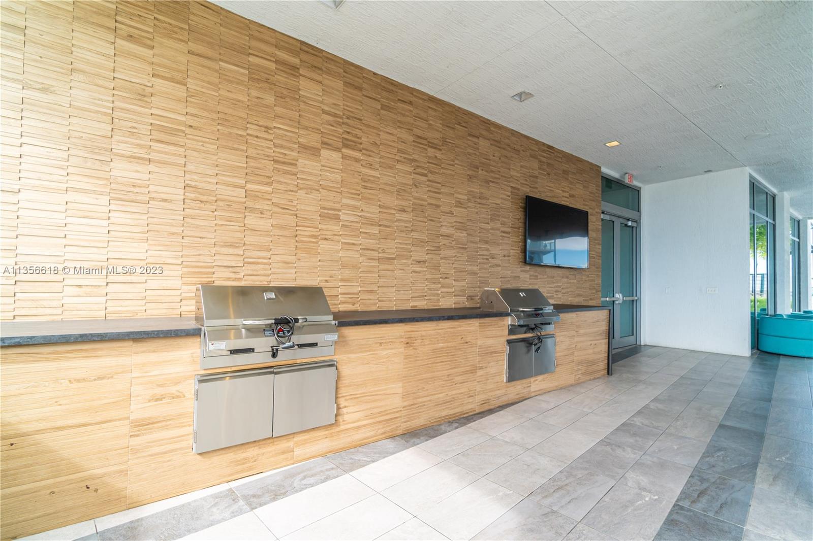 3900 Biscayne Boulevard, Unit S320 Miami, FL 33137 - Photo 35 of 42 a kitchen with stainless steel appliances kitchen island granite countertop a stove a sink and a refrigerator